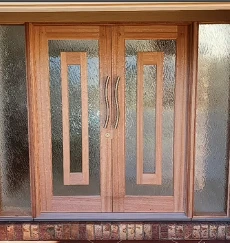 Double entry doors before: dull, faded timber