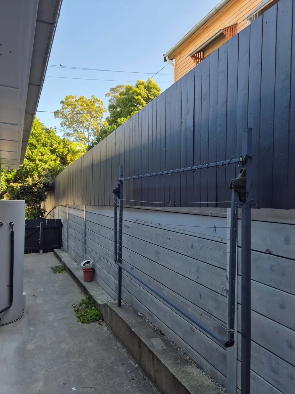 Timber fence after: painted a deep charcoal
